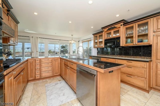 kitchen featuring dark countertops, backsplash, glass insert cabinets, black appliances, and a sink