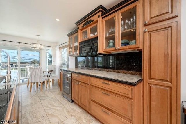 kitchen with glass insert cabinets, wine cooler, decorative backsplash, an inviting chandelier, and hanging light fixtures