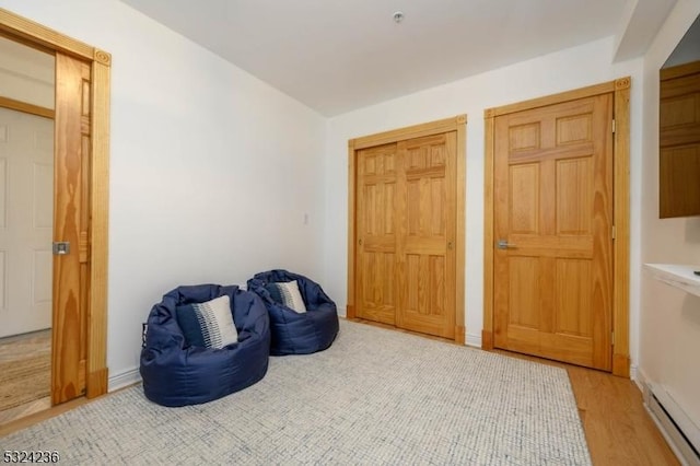 living area with baseboards and light wood finished floors