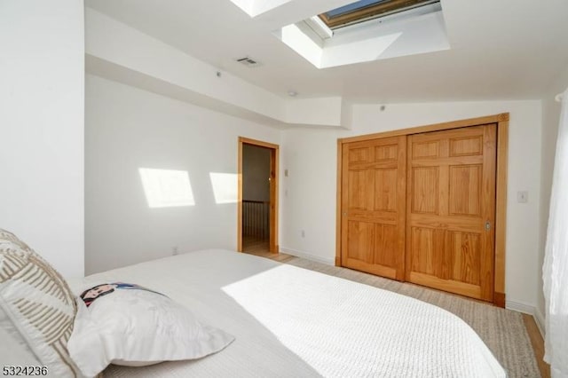 bedroom with visible vents and vaulted ceiling with skylight