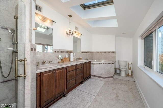 full bathroom featuring tiled shower, a skylight, an inviting chandelier, a bath, and a sink