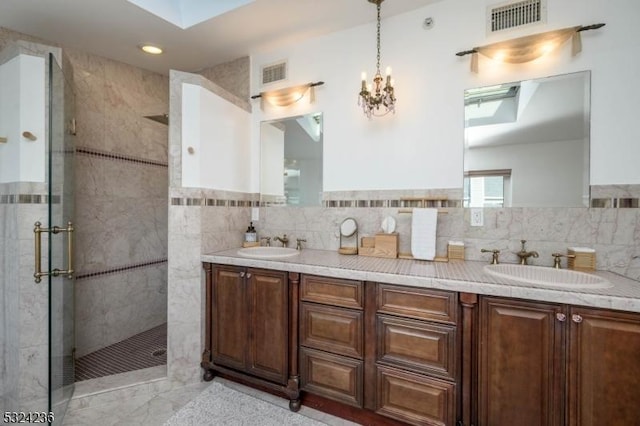 full bathroom with visible vents, a shower stall, and a sink