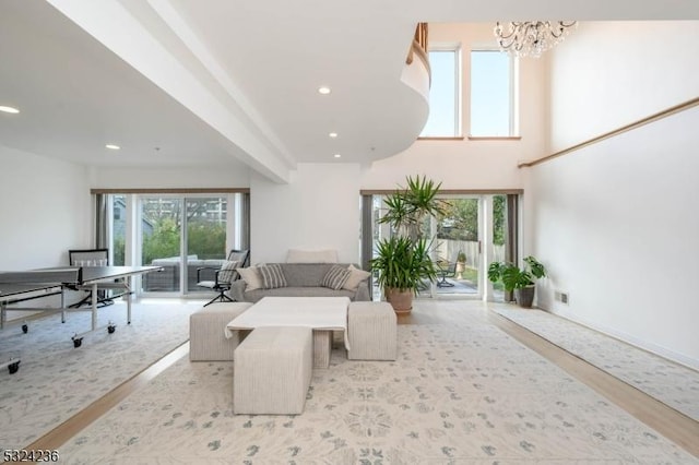 living room with visible vents, wood finished floors, recessed lighting, an inviting chandelier, and baseboards