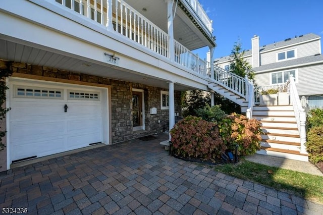 exterior space featuring stairs and stone siding