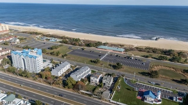 birds eye view of property featuring a beach view and a water view