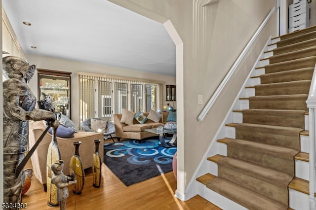 staircase with hardwood / wood-style floors