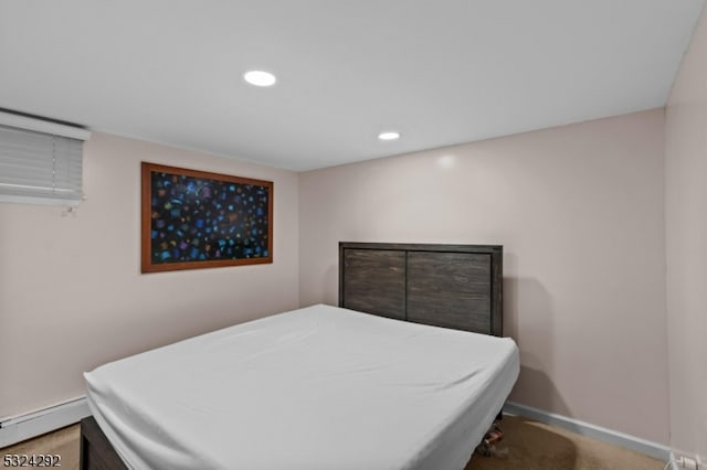 bedroom with carpet flooring and baseboard heating