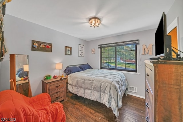 bedroom with dark wood-type flooring