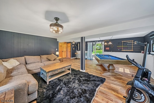 living room featuring pool table, hardwood / wood-style floors, and wooden walls