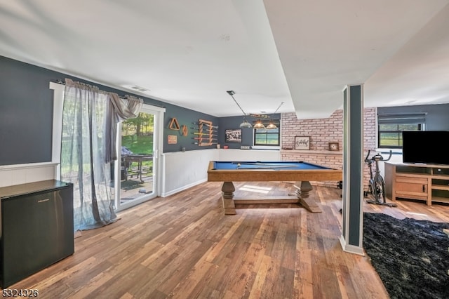 game room with pool table, light hardwood / wood-style floors, and plenty of natural light