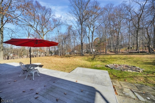 wooden deck featuring a lawn