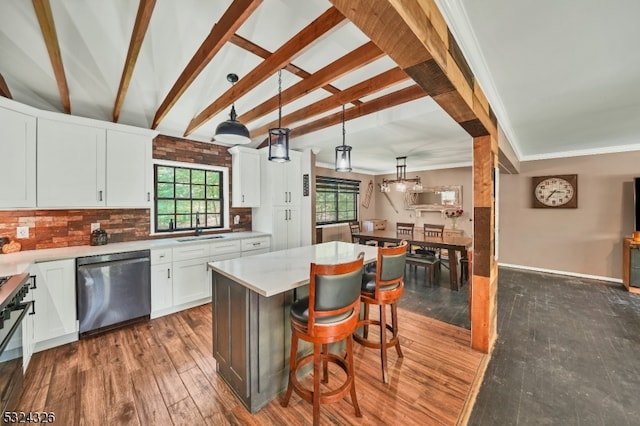 kitchen with white cabinetry, hanging light fixtures, a kitchen island, dark wood-type flooring, and dishwasher