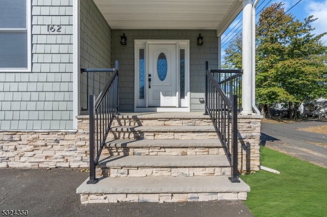 entrance to property featuring covered porch