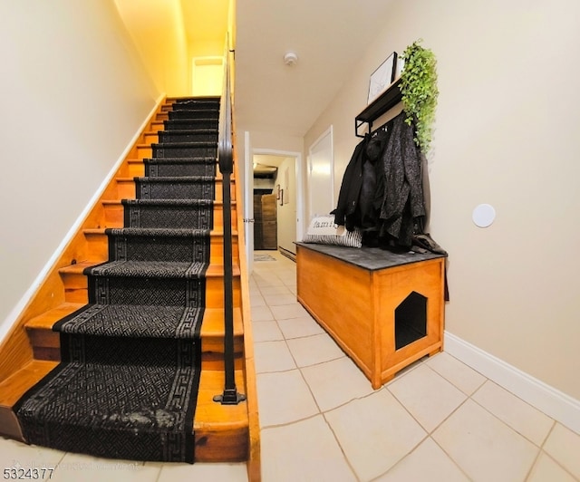 stairway with tile patterned floors