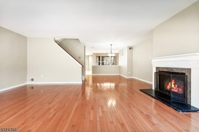 unfurnished living room with a fireplace and wood-type flooring