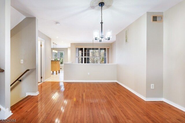 interior space with light hardwood / wood-style flooring and a notable chandelier