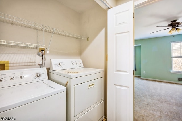 clothes washing area with ceiling fan, independent washer and dryer, and light carpet