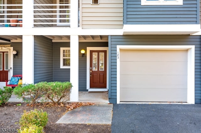 doorway to property with a balcony and a garage