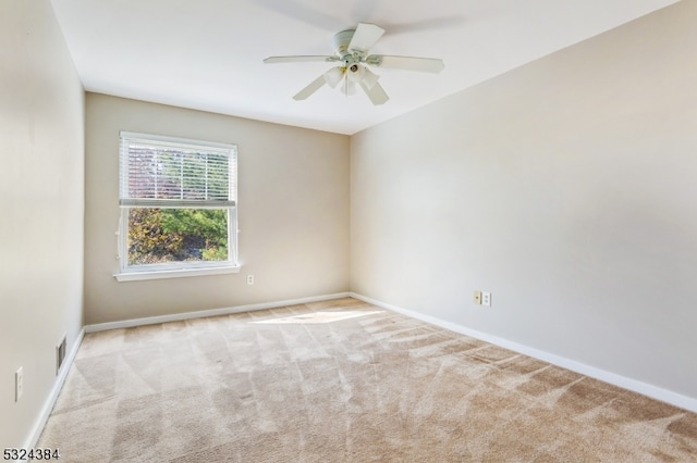 spare room with light colored carpet and ceiling fan