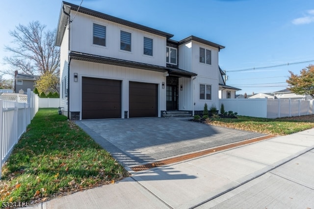 view of front of house with a garage and a front yard