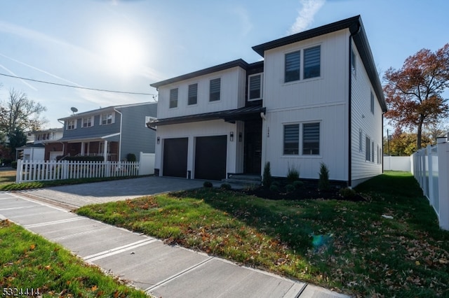 view of front of house featuring a garage and a front yard