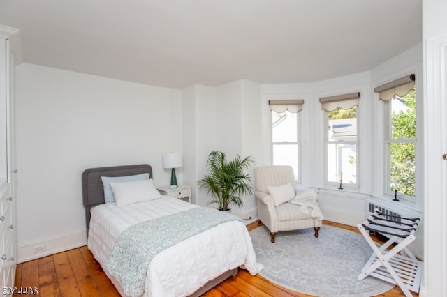 bedroom with hardwood / wood-style floors