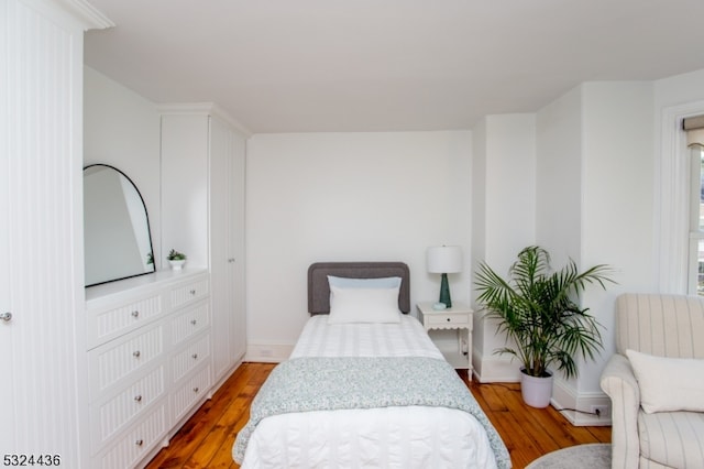 bedroom with hardwood / wood-style flooring