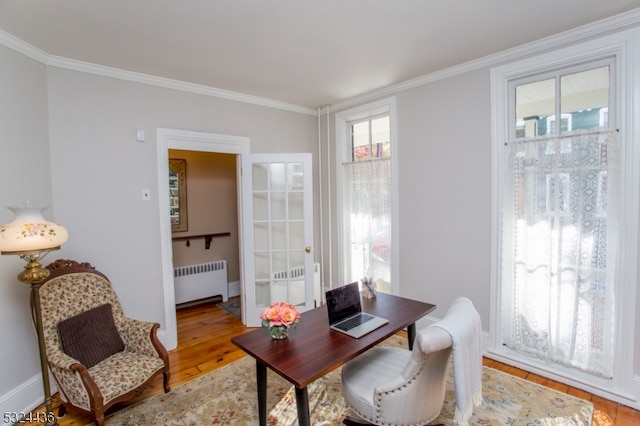 home office with radiator, ornamental molding, and hardwood / wood-style flooring