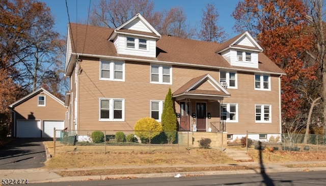 view of front of house featuring a garage and an outdoor structure