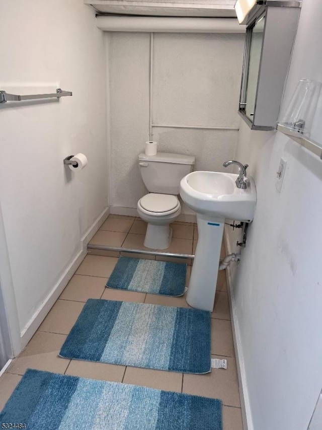 bathroom with tile patterned floors and toilet