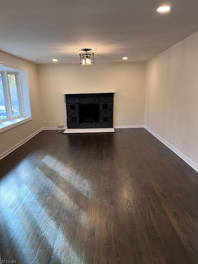 unfurnished living room with dark hardwood / wood-style floors and a fireplace