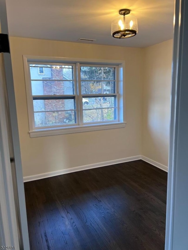 unfurnished dining area featuring plenty of natural light and dark hardwood / wood-style floors