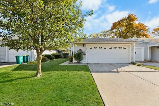 view of front of property with a garage and a front lawn