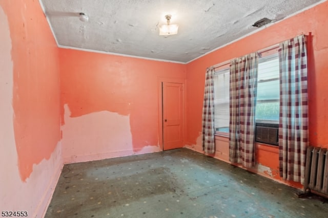 spare room featuring radiator