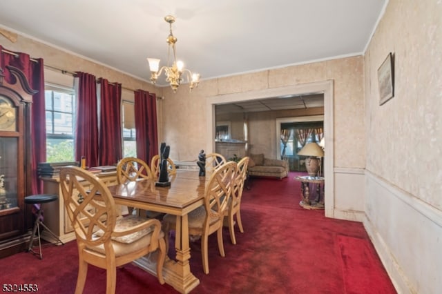 dining area with carpet, an inviting chandelier, and crown molding