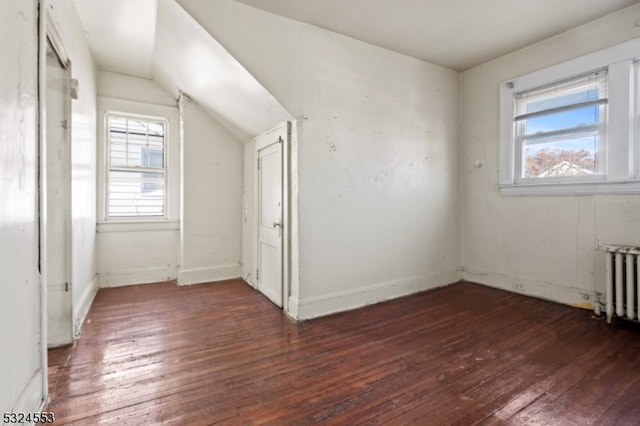 bonus room featuring dark hardwood / wood-style flooring, vaulted ceiling, and plenty of natural light