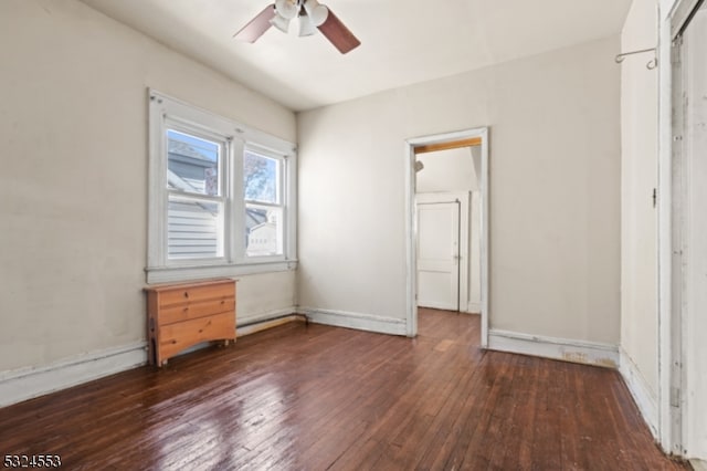 unfurnished bedroom with ceiling fan and dark wood-type flooring