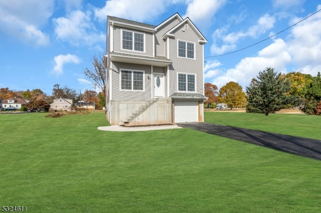 front facade featuring a garage and a front lawn