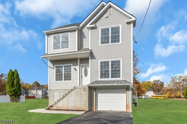 front facade featuring a garage and a front yard