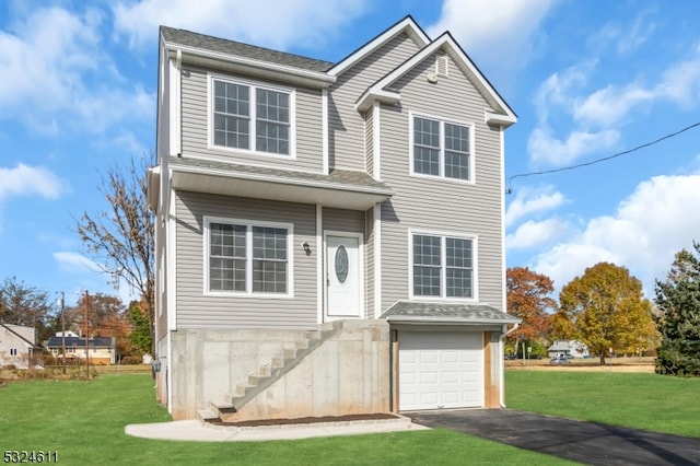 view of front of home with a front lawn and a garage