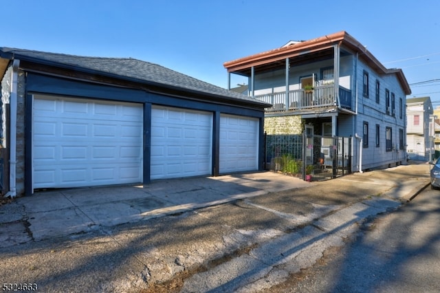 view of front of property featuring a balcony and a garage