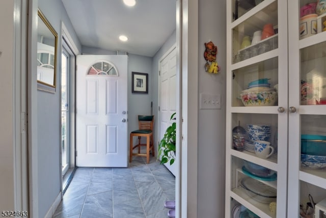 entryway featuring vaulted ceiling