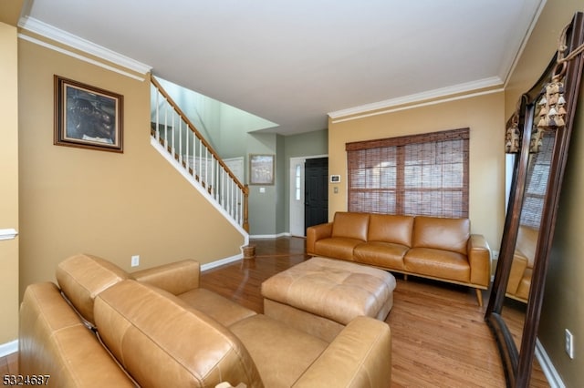 living room featuring light hardwood / wood-style floors and ornamental molding