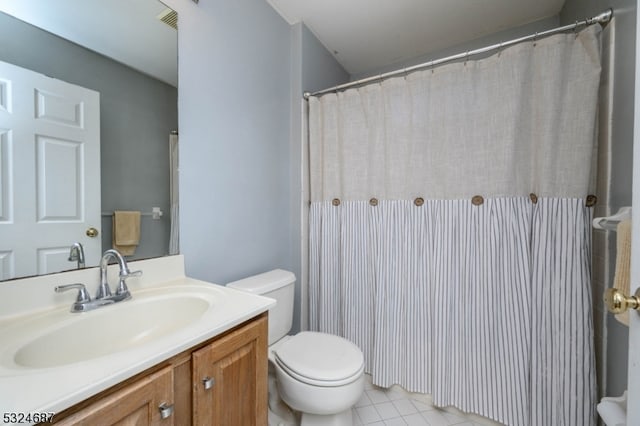 bathroom featuring tile patterned floors, vanity, and toilet