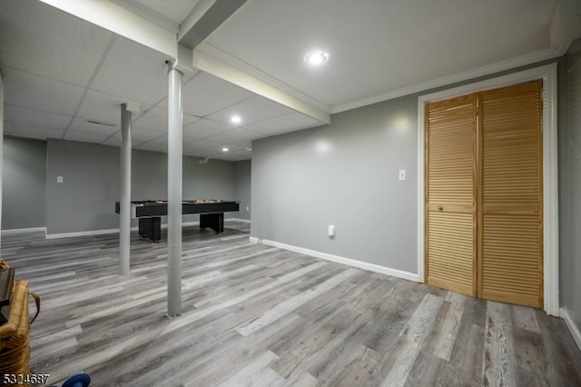 basement with hardwood / wood-style floors, a drop ceiling, ornamental molding, and billiards