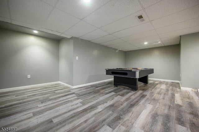 recreation room with a drop ceiling and hardwood / wood-style flooring