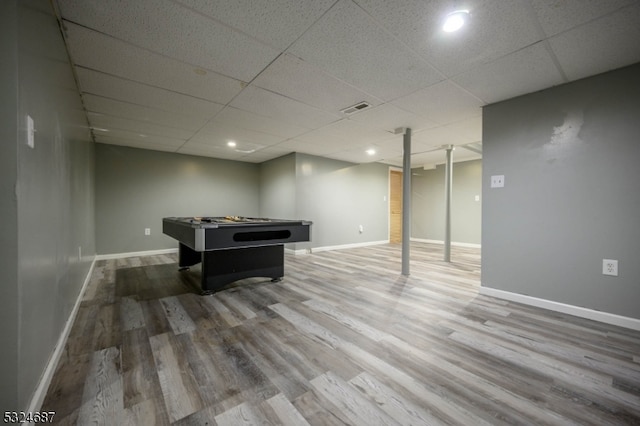 rec room with hardwood / wood-style floors and a drop ceiling