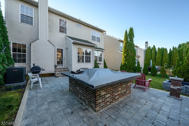 back of property featuring cooling unit and a patio area