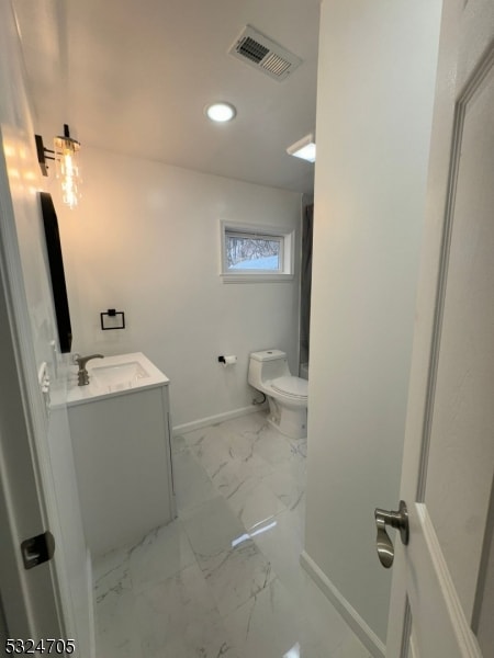 bathroom with vanity and toilet