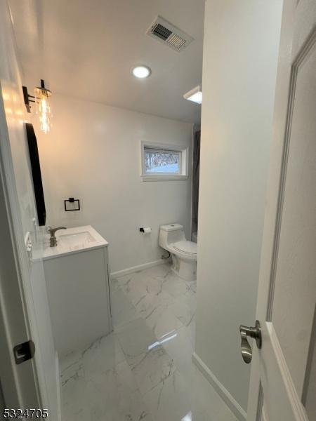 111 E Del A Vue Ave, Carneys Point Twp, NJ 08069 - bathroom with vanity, marble look tiles, toilet, recessed lighting, and baseboards